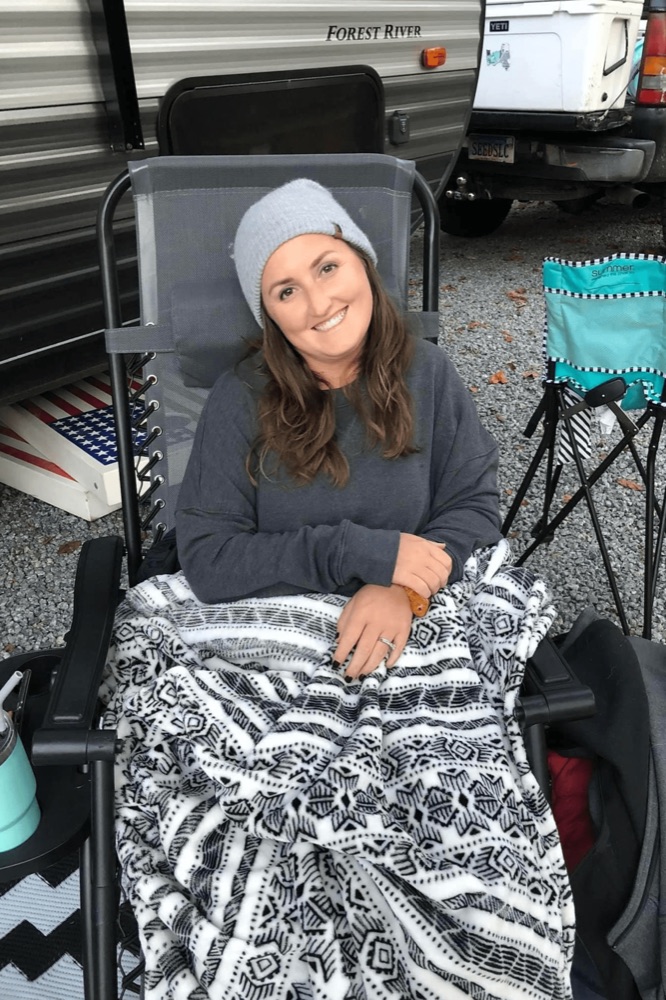 Angela outdoors on a camping trip, the family story behind AES Cancer Foundation.