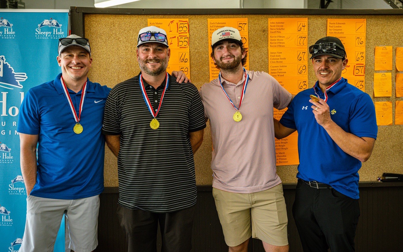 A team wearing their medals at the AES Cancer Foundation golf tournament.